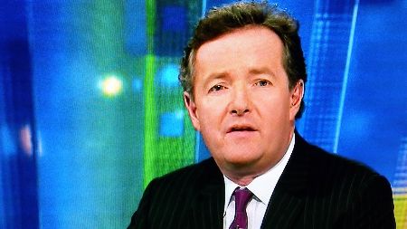 Piers Morgan in a black suit caught on the camera.
